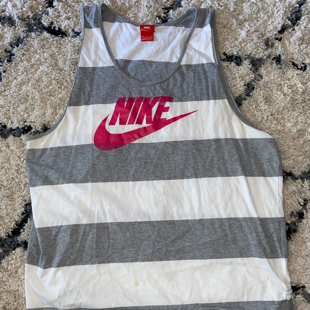 Nike gray striped shirt with pink logo.